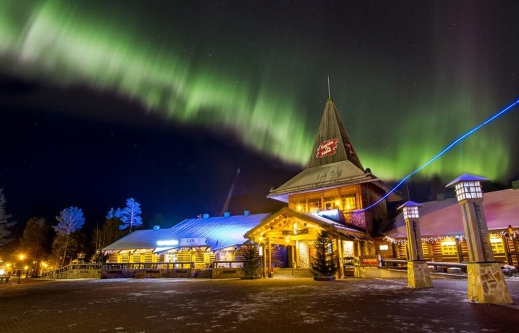 Santa claus village under northern lights opt